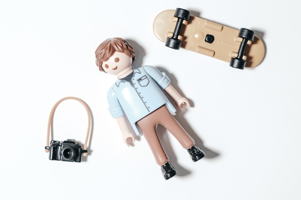 girl in blue dress holding camera figurine