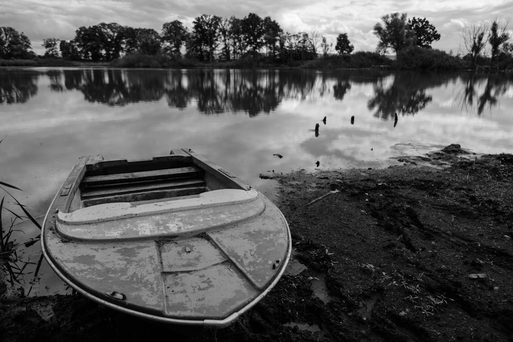 grayscale photo of boat on lake