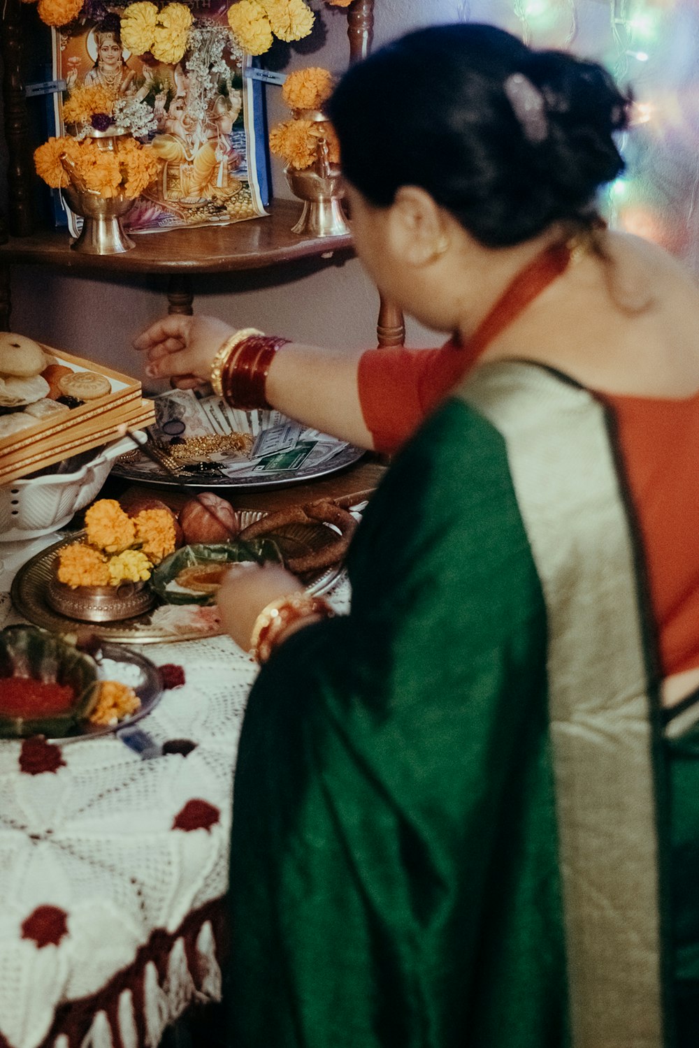 man in white and red shirt sitting beside woman in green dress