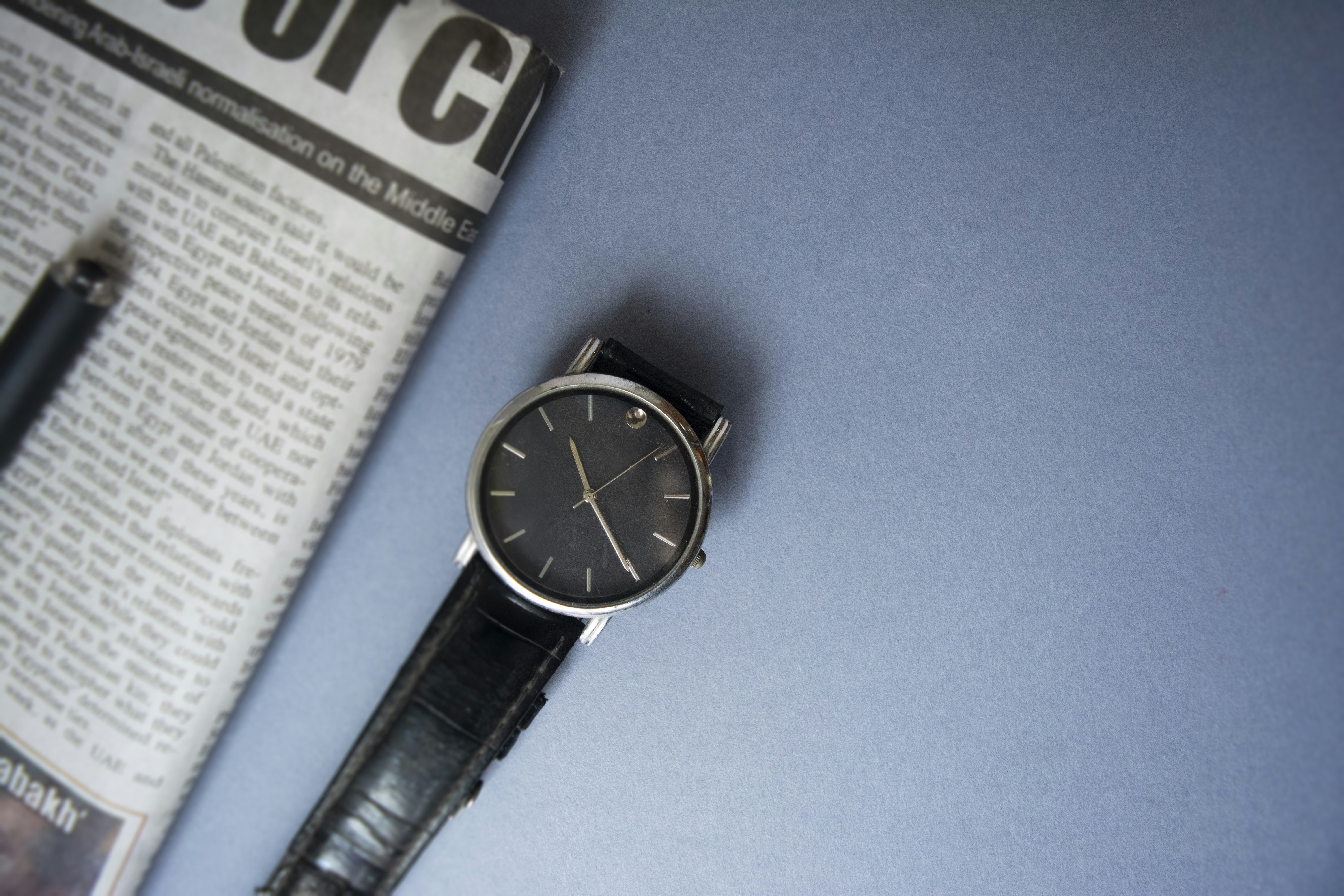 black leather strap silver round analog watch