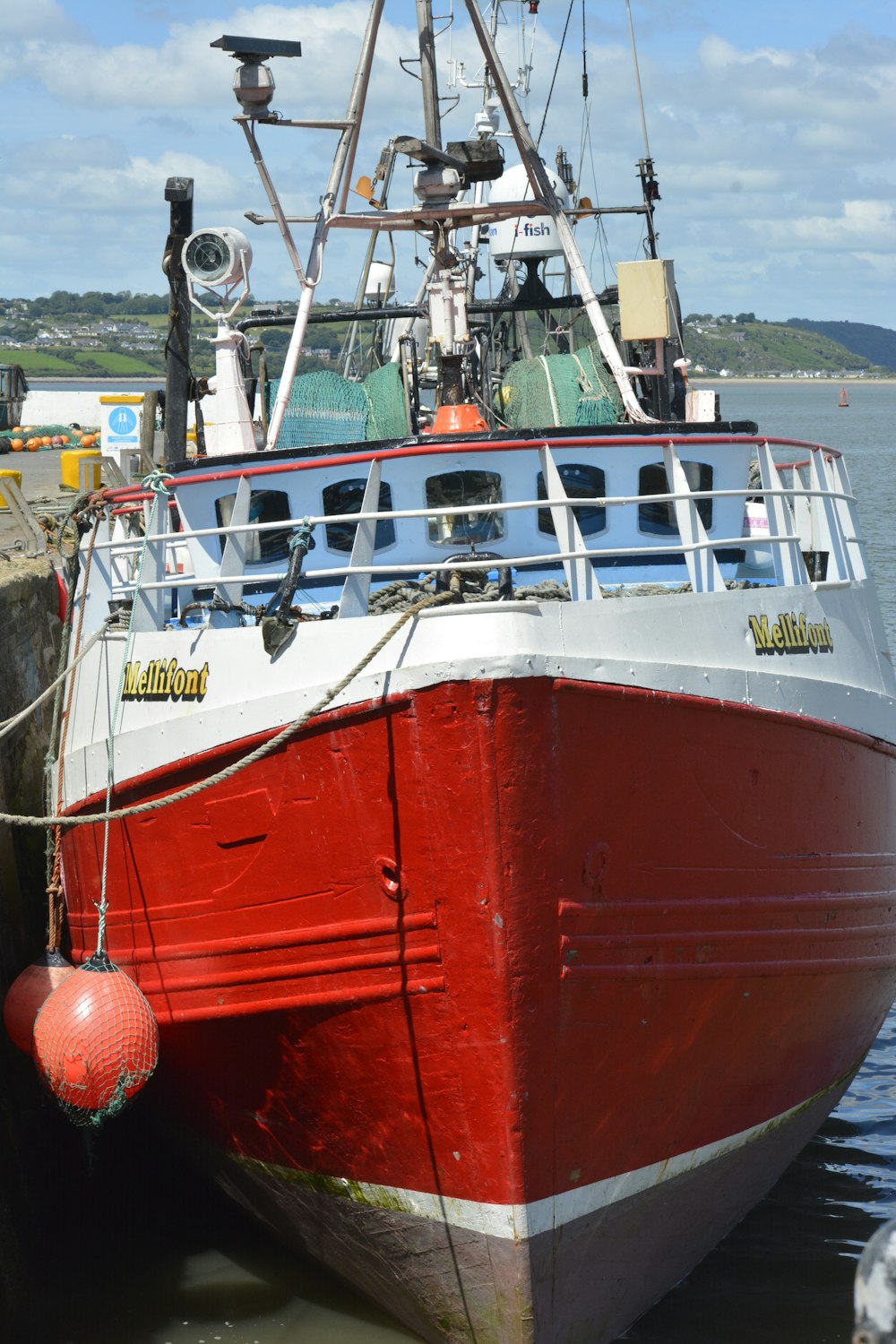 red and white boat on sea during daytime