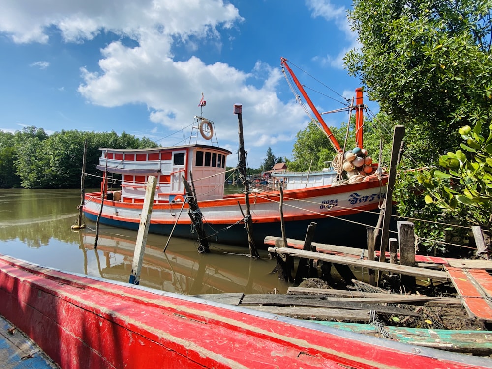 red and white boat on water