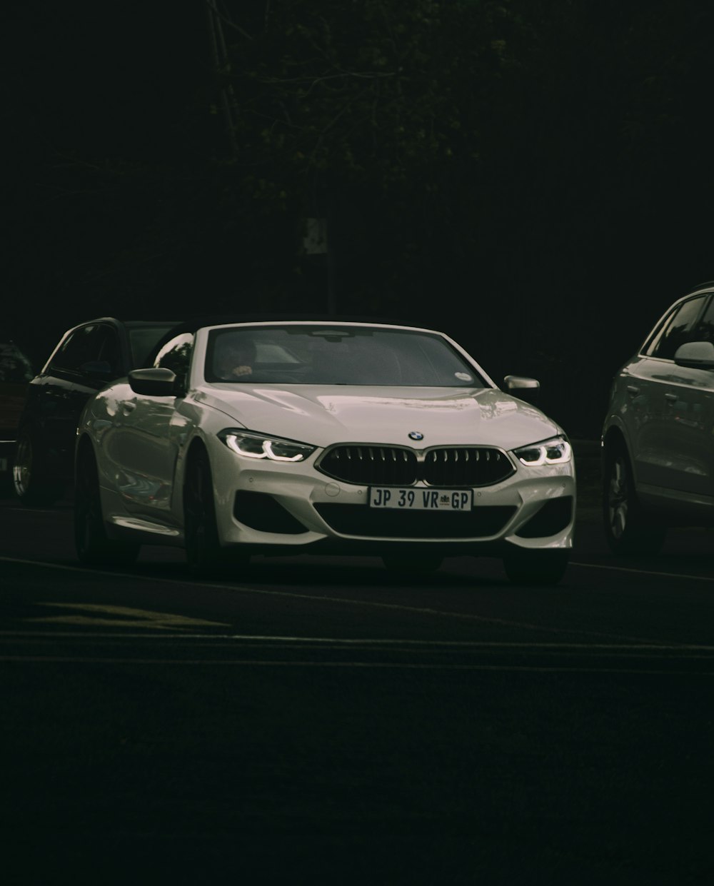 white bmw m 3 coupe on road during night time