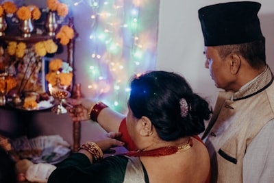 woman in black tank top kissing man in gray shirt deepavali teams background