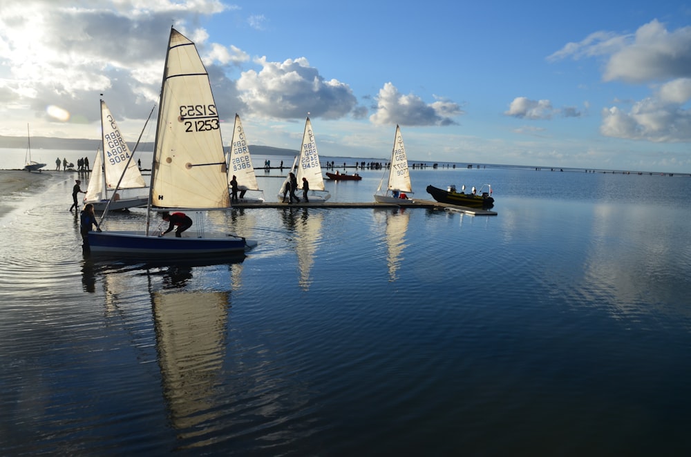 white sail boat on body of water during daytime