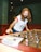 woman in white and black crew neck t-shirt playing chess