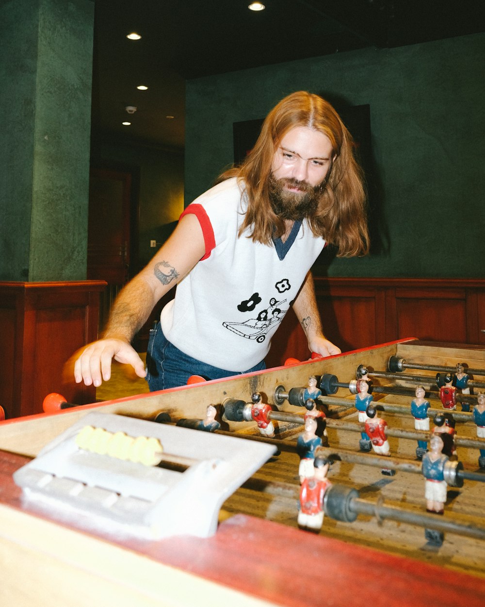 woman in white and black crew neck t-shirt playing chess