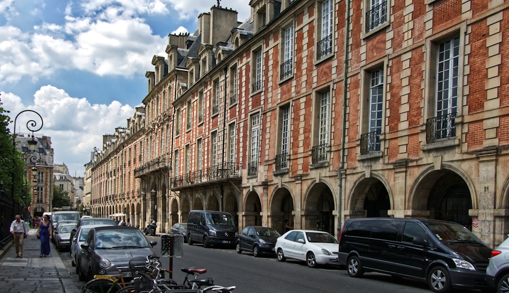 cars parked in front of brown building