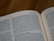 An open book with visible black text on white pages. The text appears to be in English and features a passage from the Old Testament. The focus is on the left-hand page, which includes content relating to commandments and blessings.