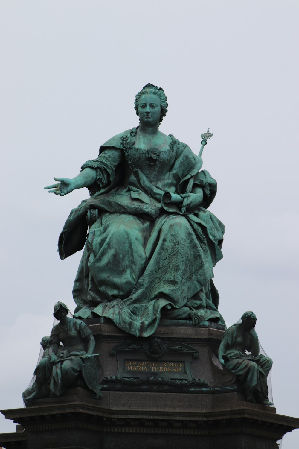 statue of woman holding book