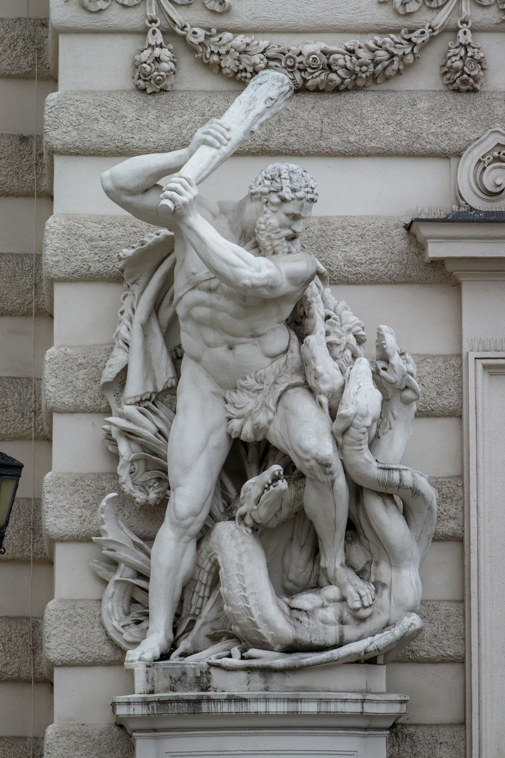 statue of man holding book