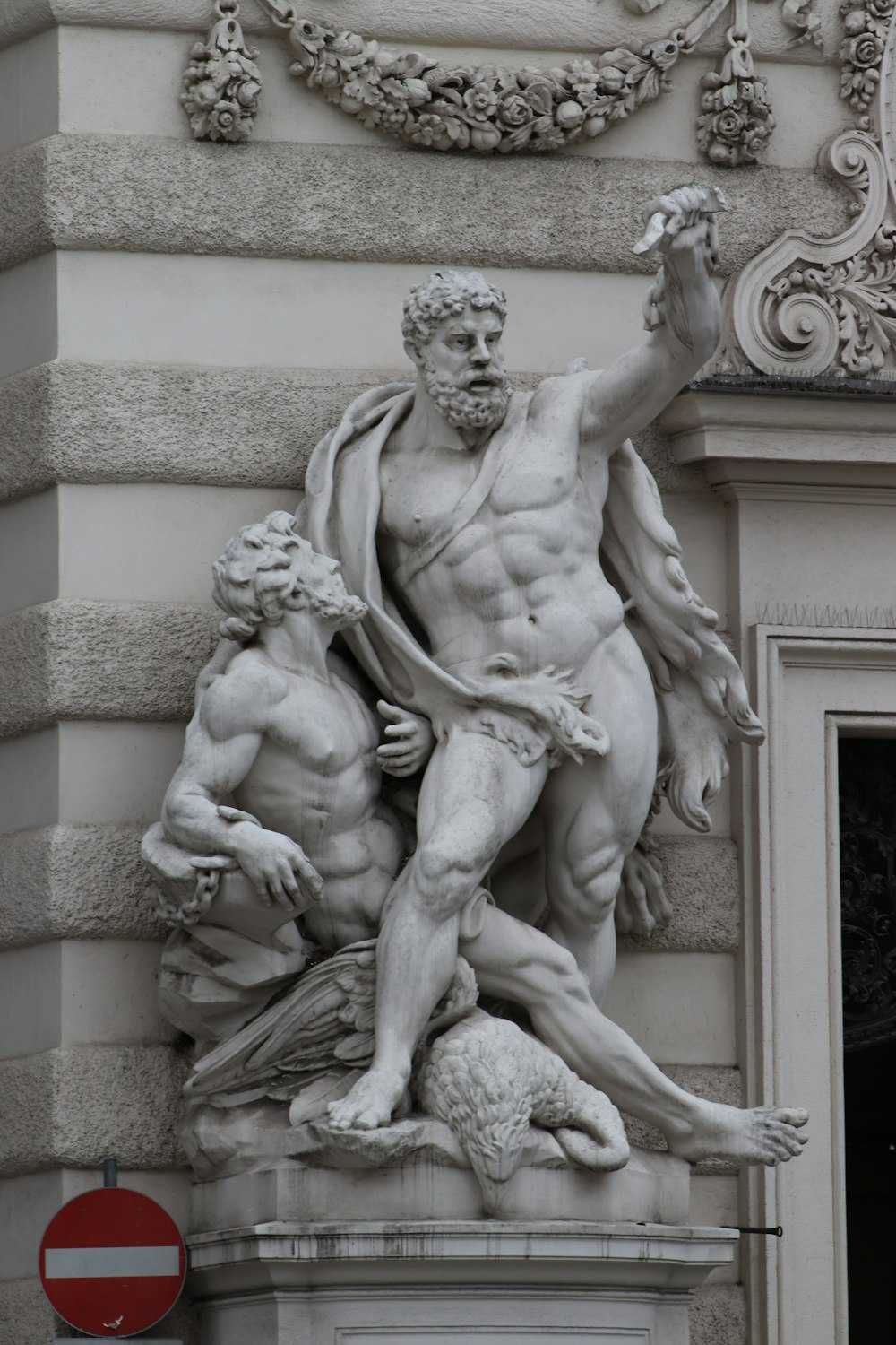 Man Statue in der Nähe eines braunen Betongebäudes tagsüber