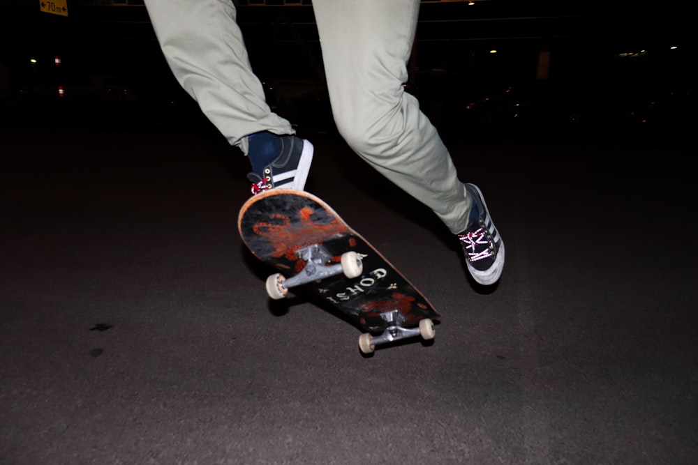 person in white pants and black and white nike sneakers