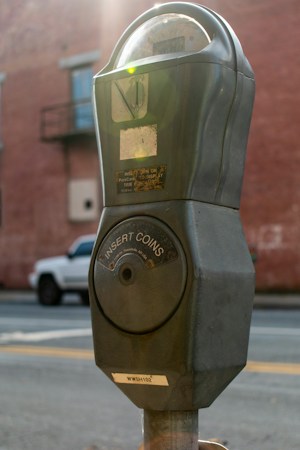 A black and gray street parking meter, the kind of meter behind many expired meter tickets that qualify for the City of Las Vegas toys for tickets program