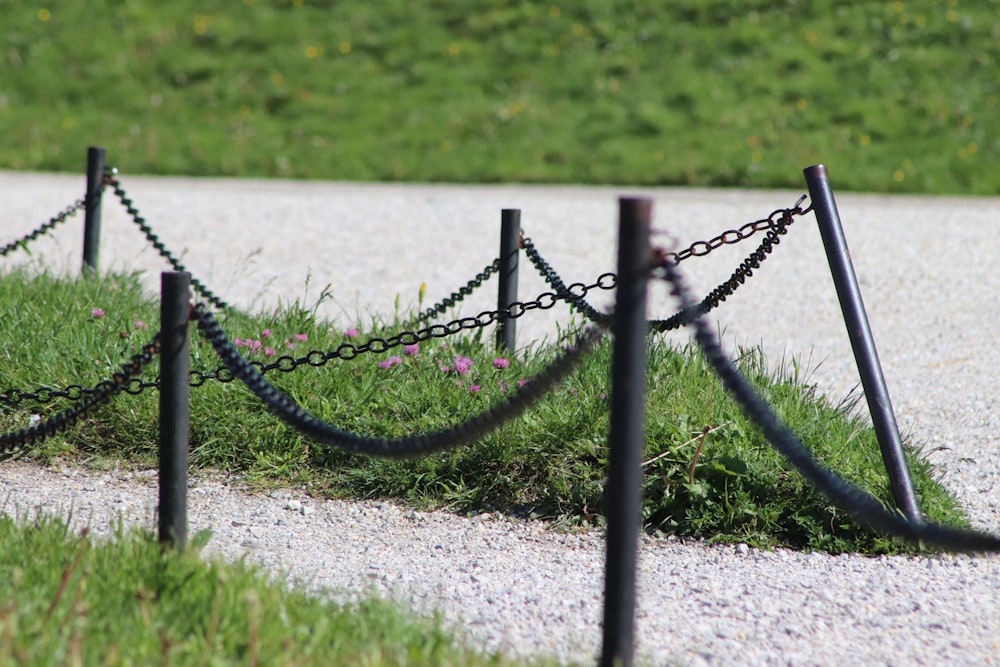 black metal fence on gray concrete road during daytime