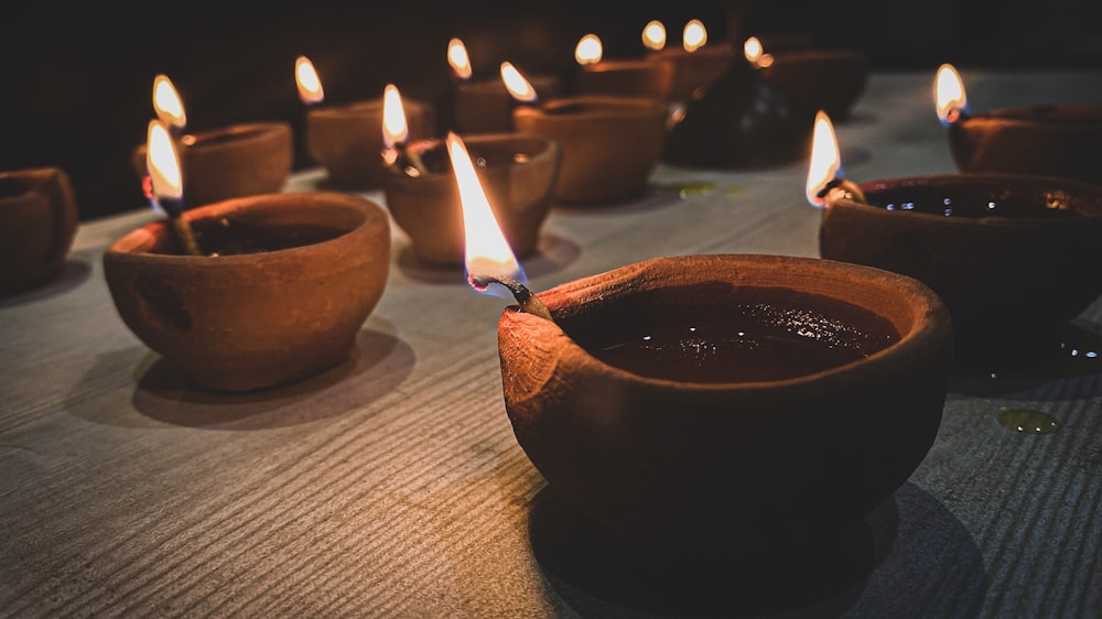 lighted candle in brown round bowl