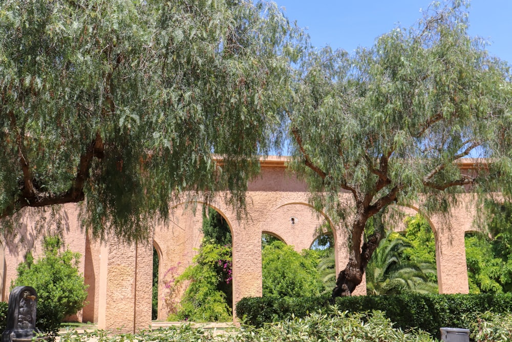 green trees near brown brick building during daytime