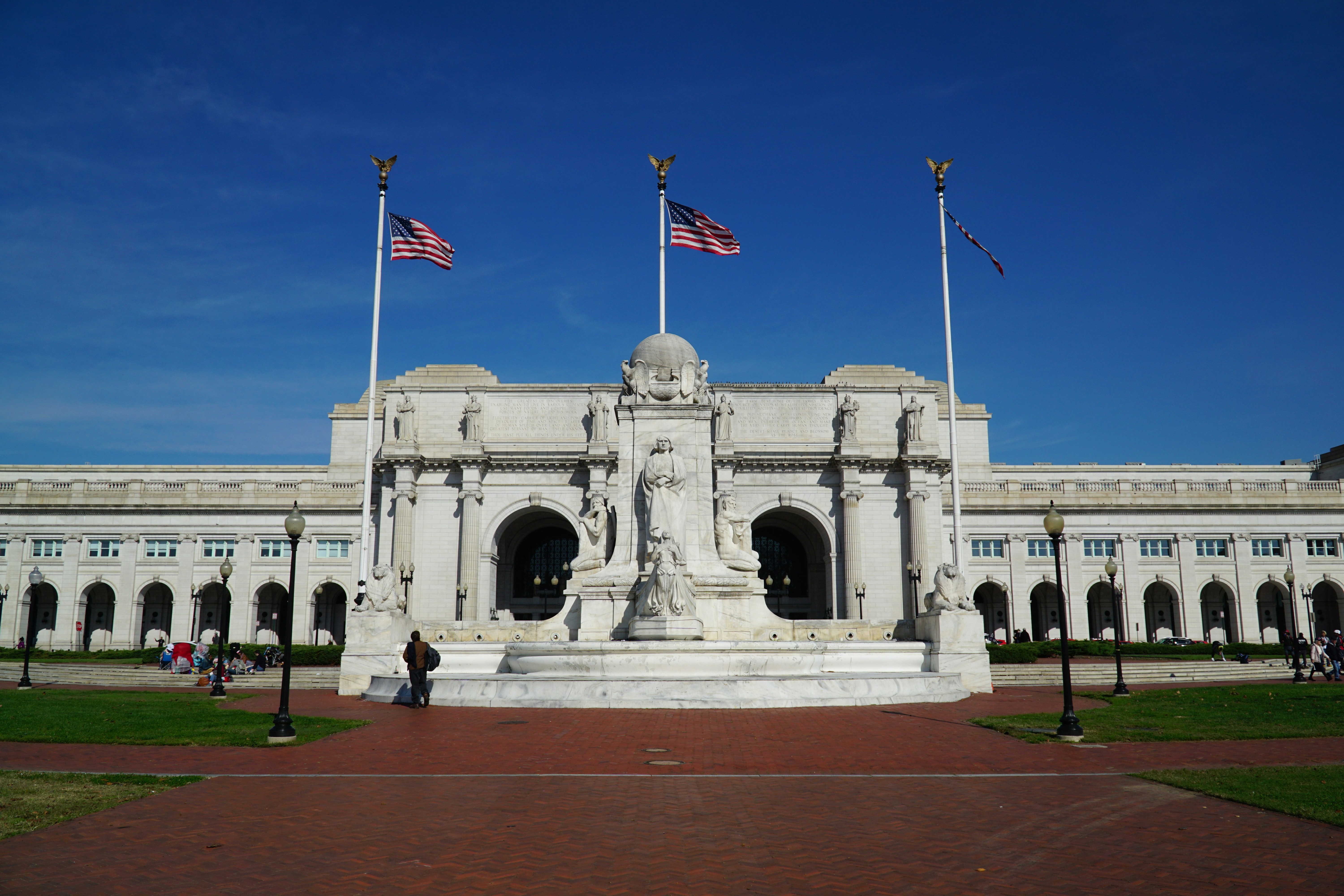 us a flag on white concrete building during daytime