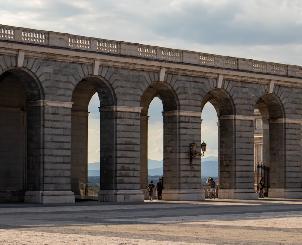 people walking on gray concrete bridge during daytime