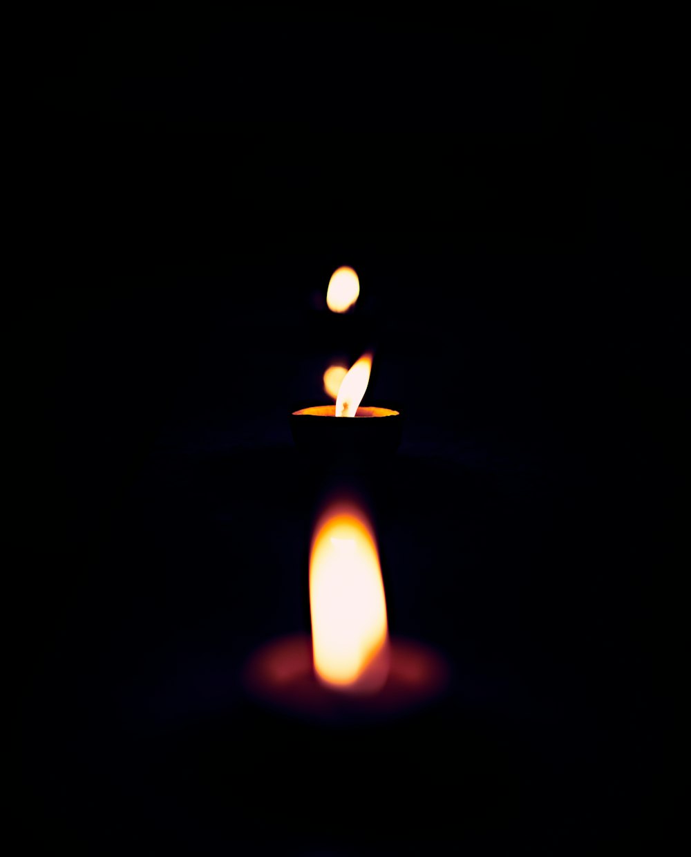 lighted candle in dark room