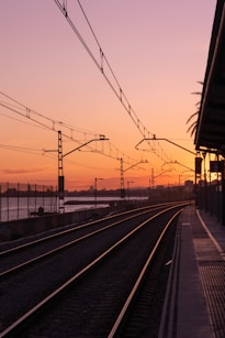 train rail near train tracks during daytime