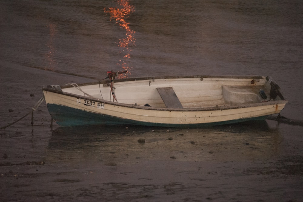 white and green boat on water during daytime