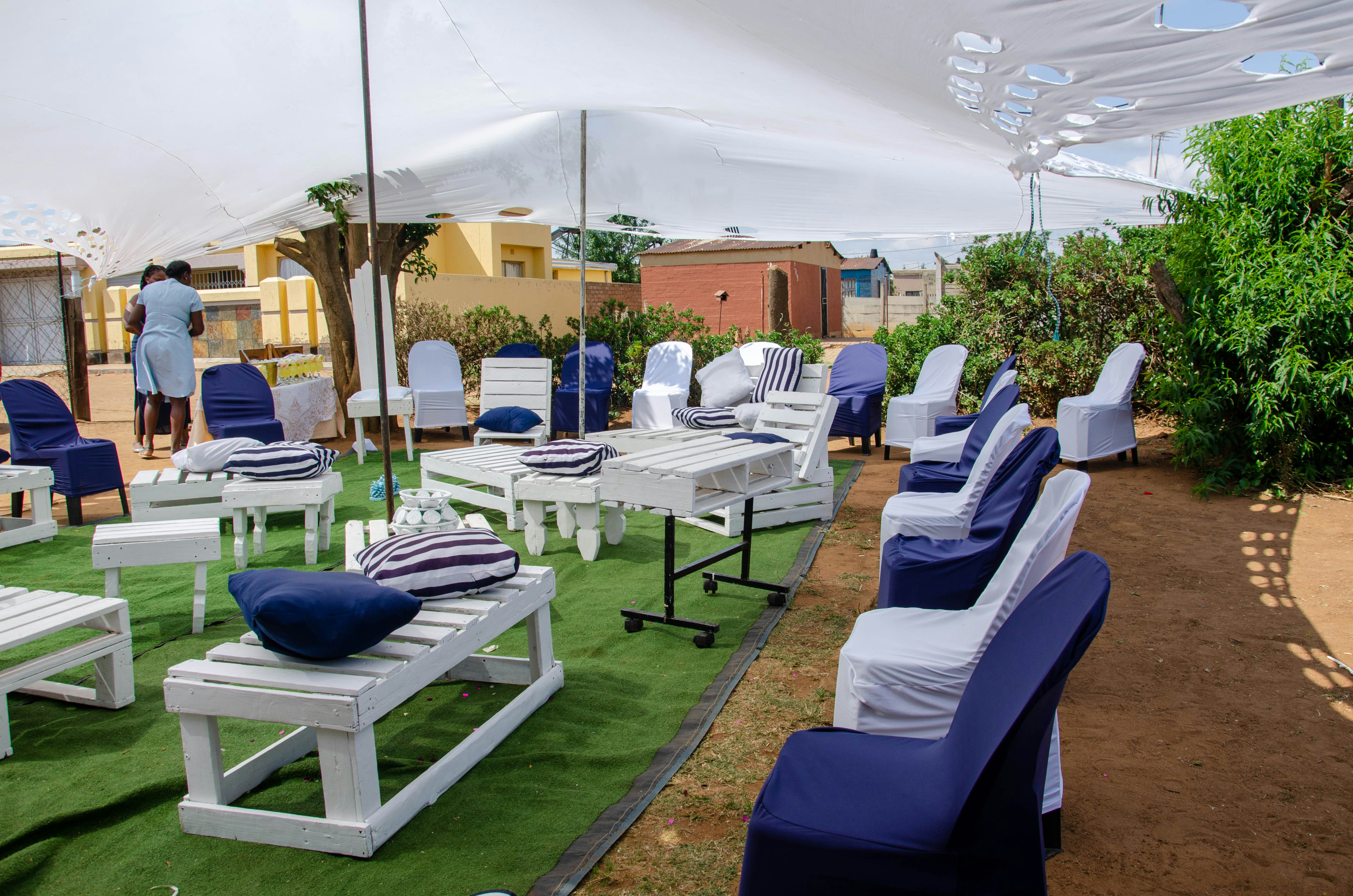 White tent setup with chairs and tables arranged for an outdoor event