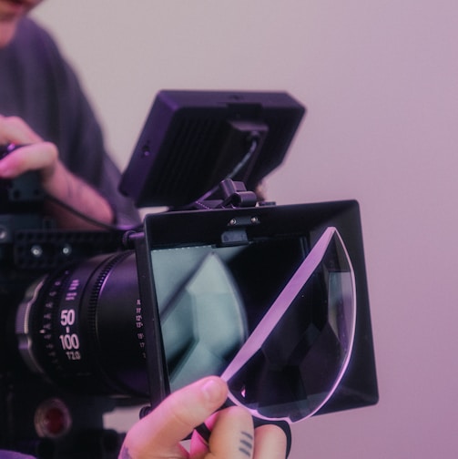 person holding black nikon dslr camera