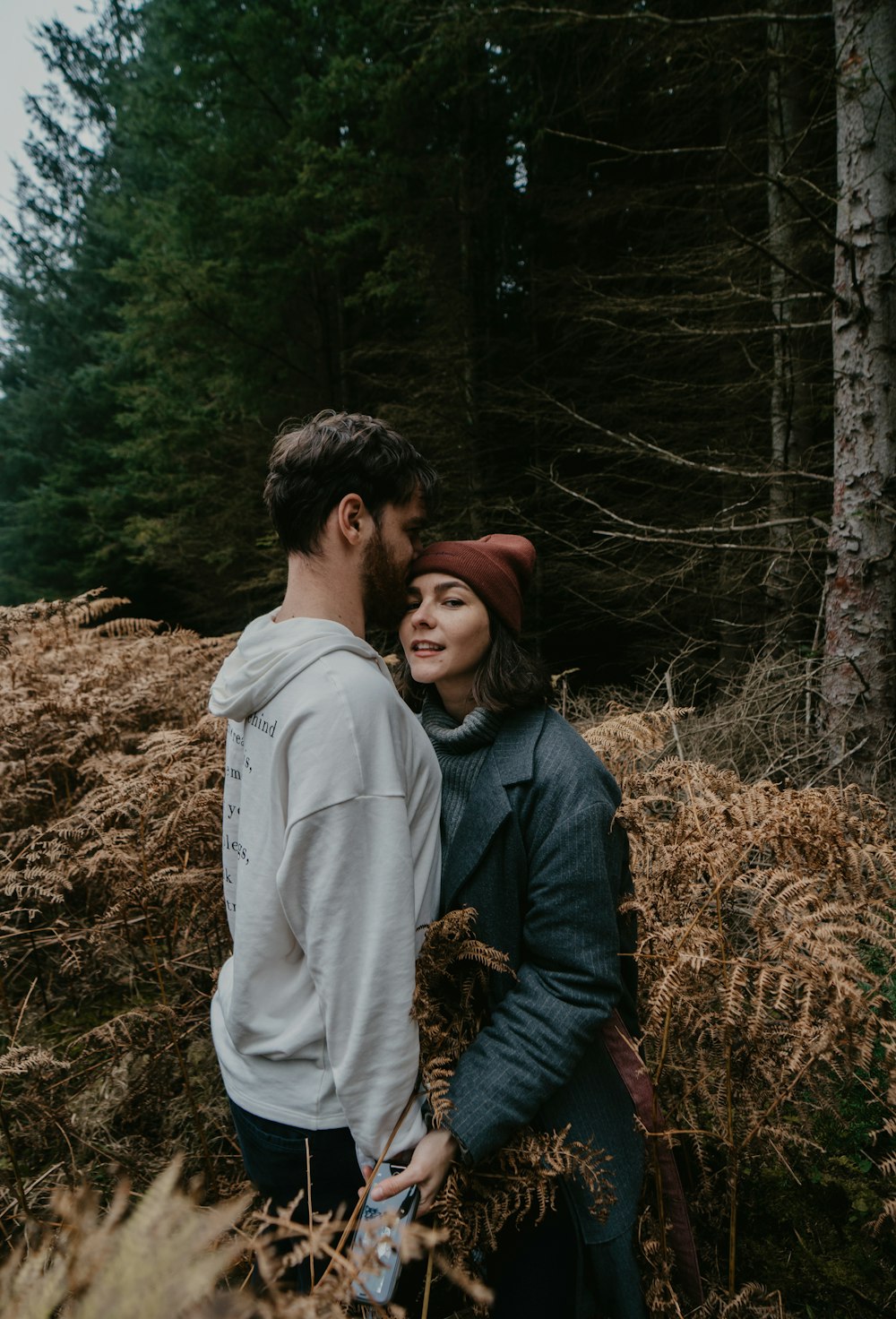 man and woman sitting on brown grass field during daytime