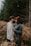 man and woman kissing on brown grass field during daytime