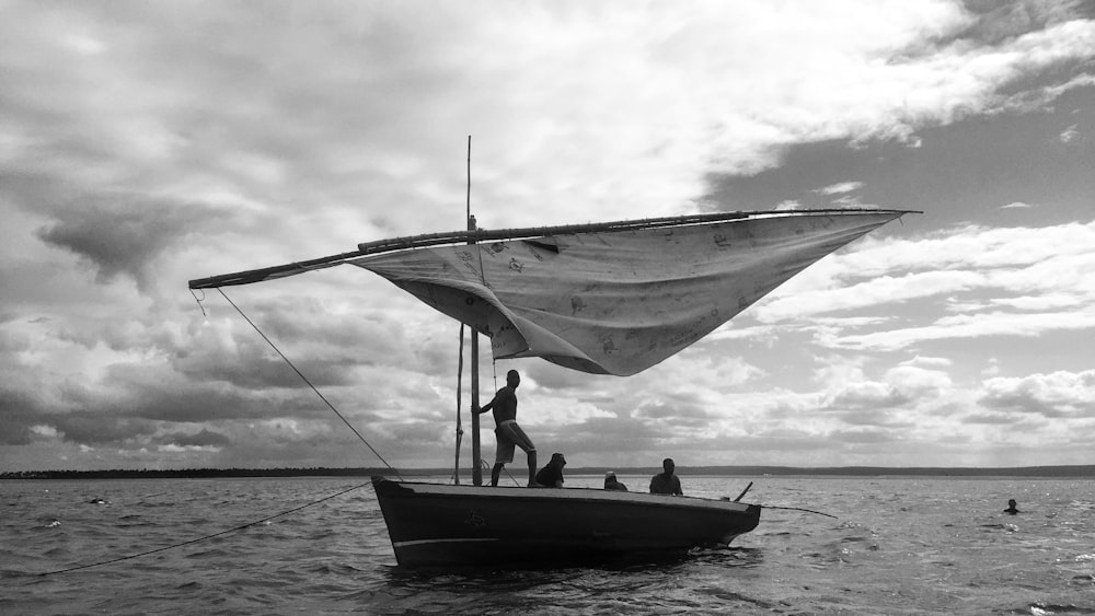 grayscale photo of 2 people on boat