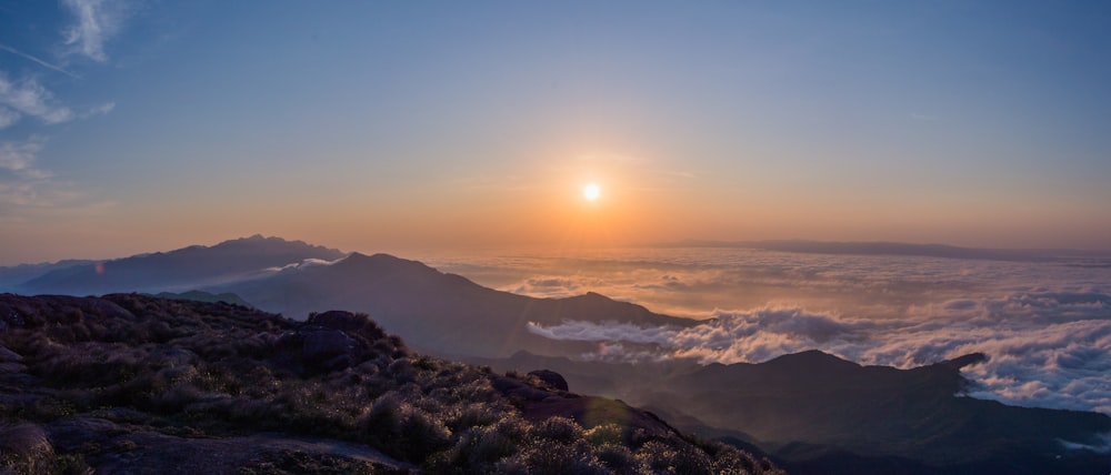 mountains and clouds during sunrise