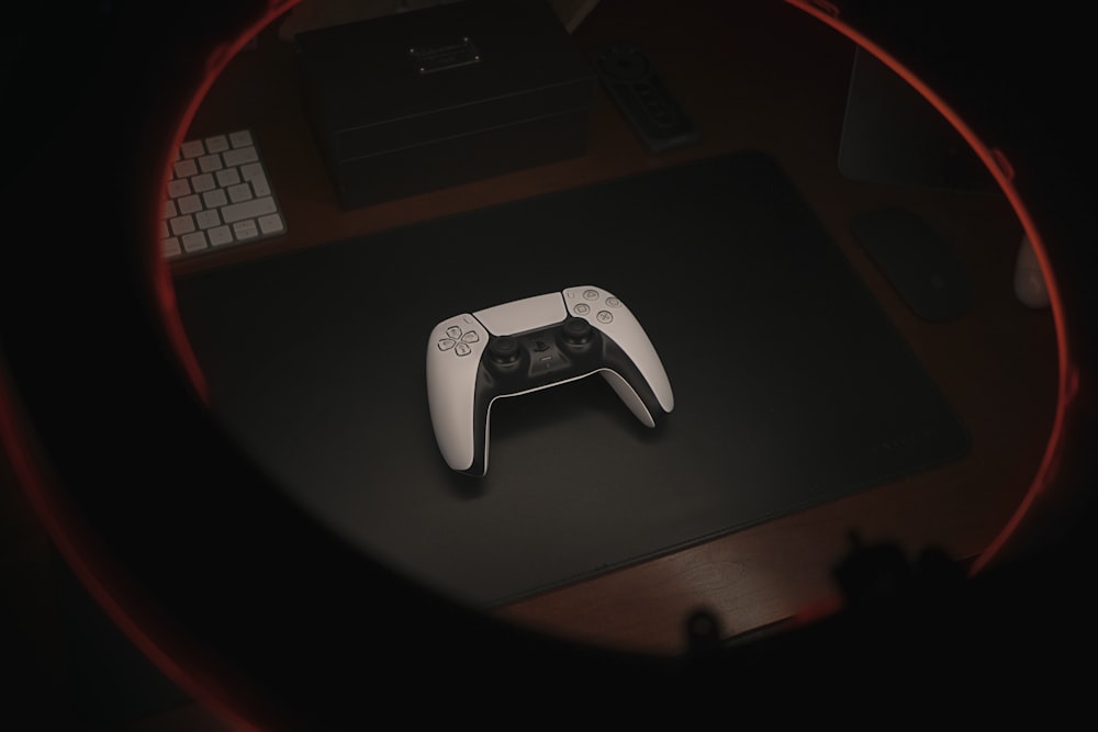 white game controller on black table