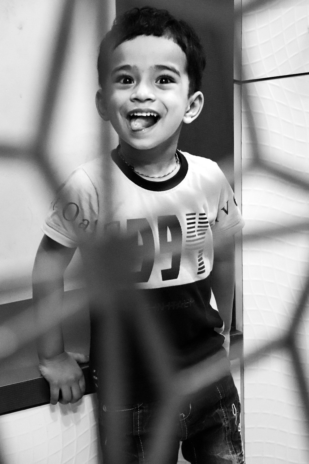 grayscale photo of boy in crew neck t-shirt