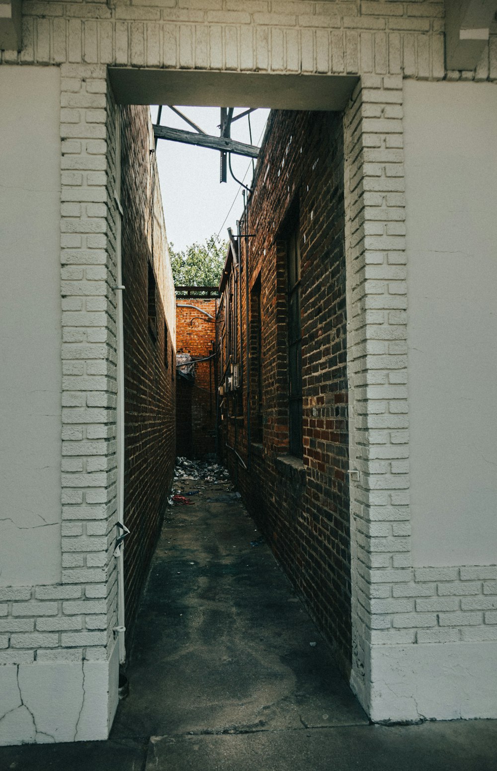 a narrow alley way with a brick building in the background