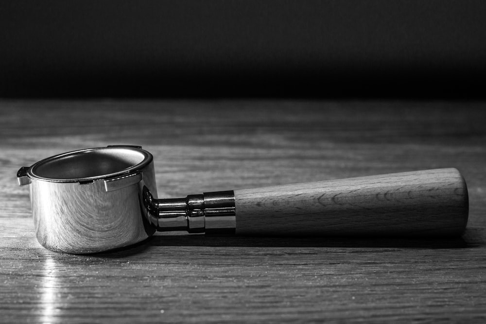 silver spoon beside white ceramic mug