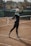 woman in black long sleeve shirt and black leggings standing on track field