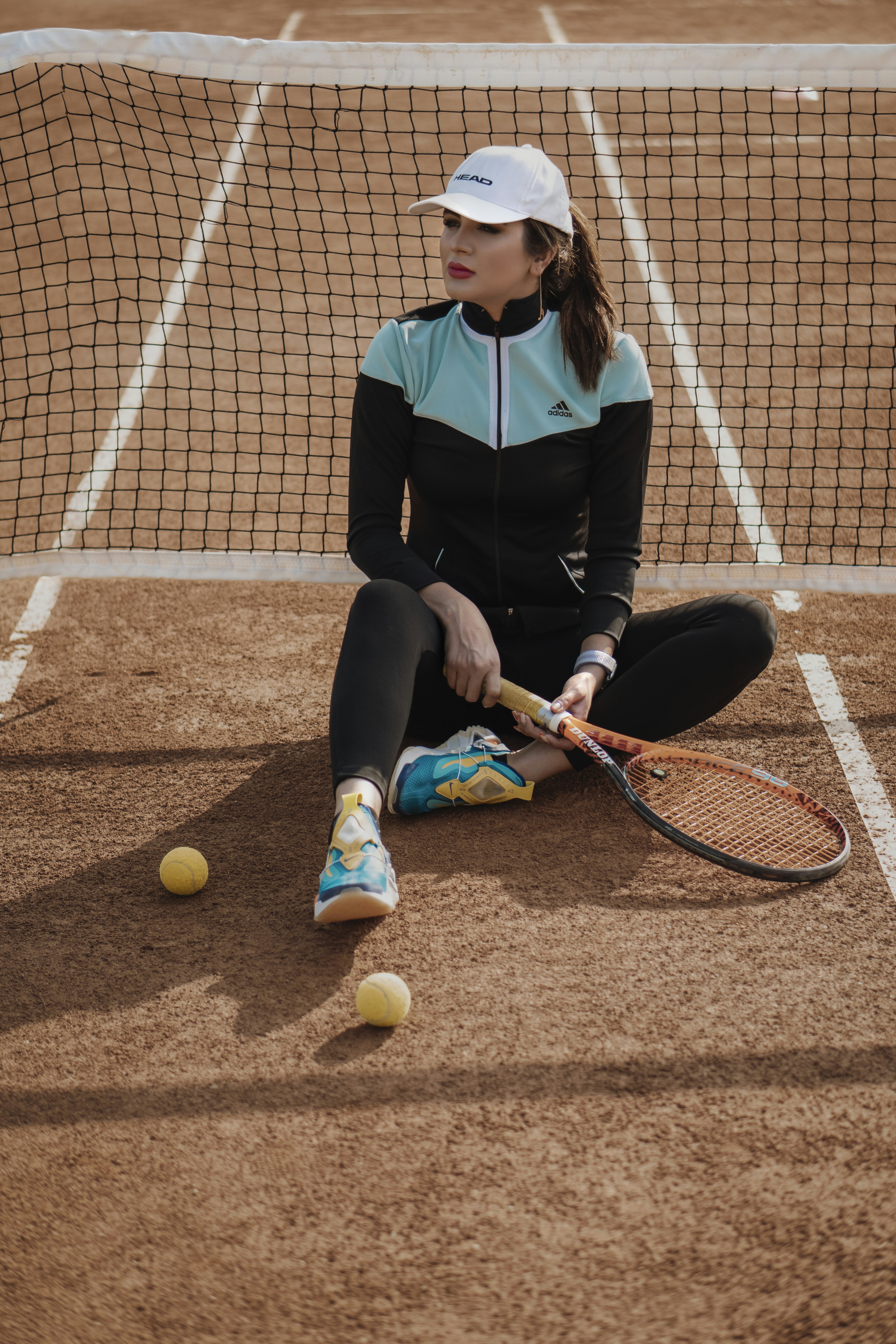 woman in black long sleeve shirt and black pants holding tennis racket