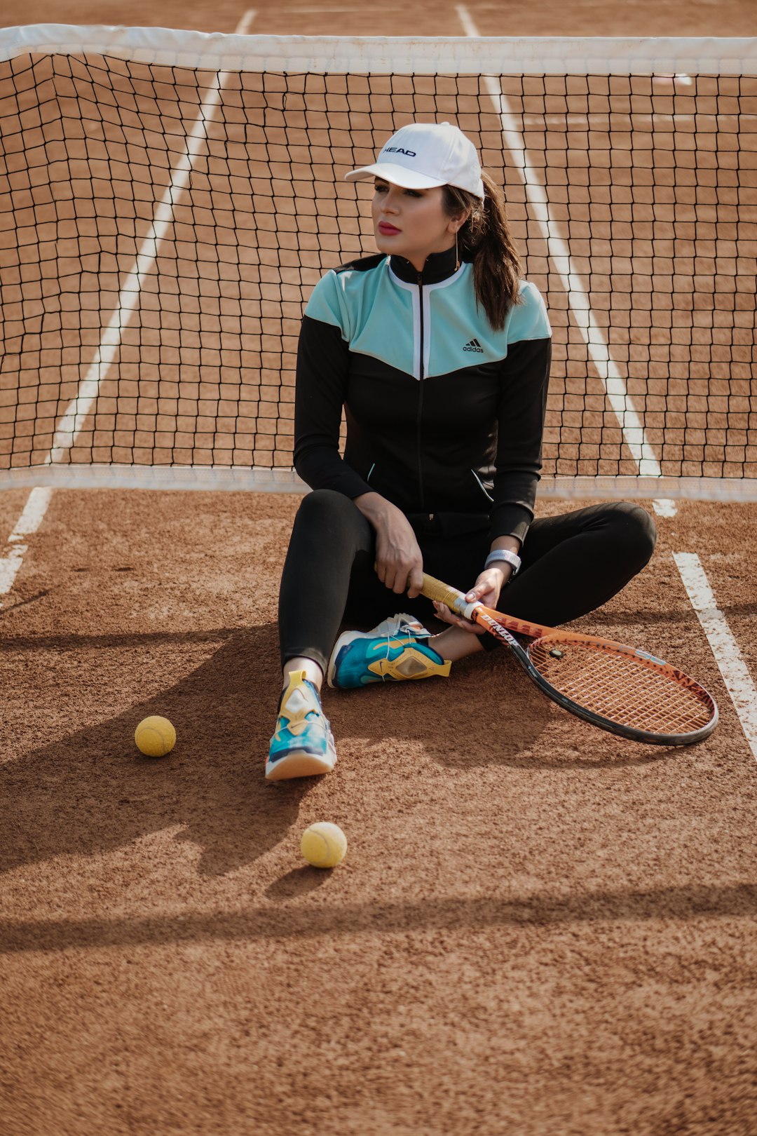 woman in black long sleeve shirt and black pants holding tennis racket