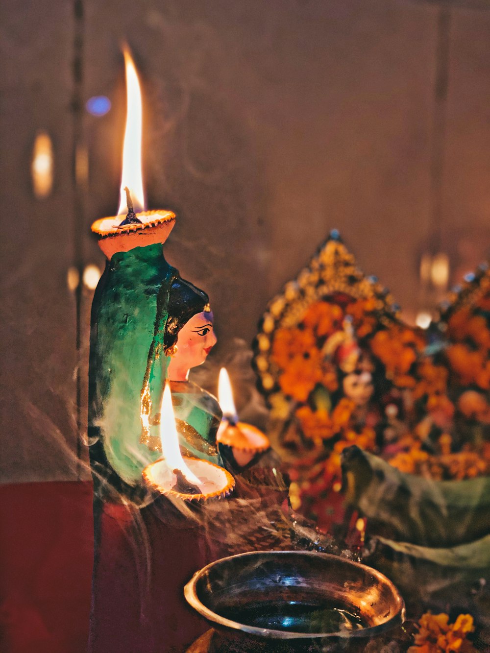 woman in green dress holding candle