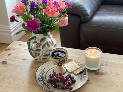 A cozy setting with candles and flowers.