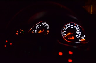 Close-up of a high-performance car dashboard with racing gauges.