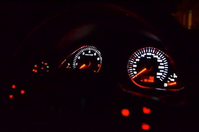 Close-up of a high-performance car dashboard with racing gauges.