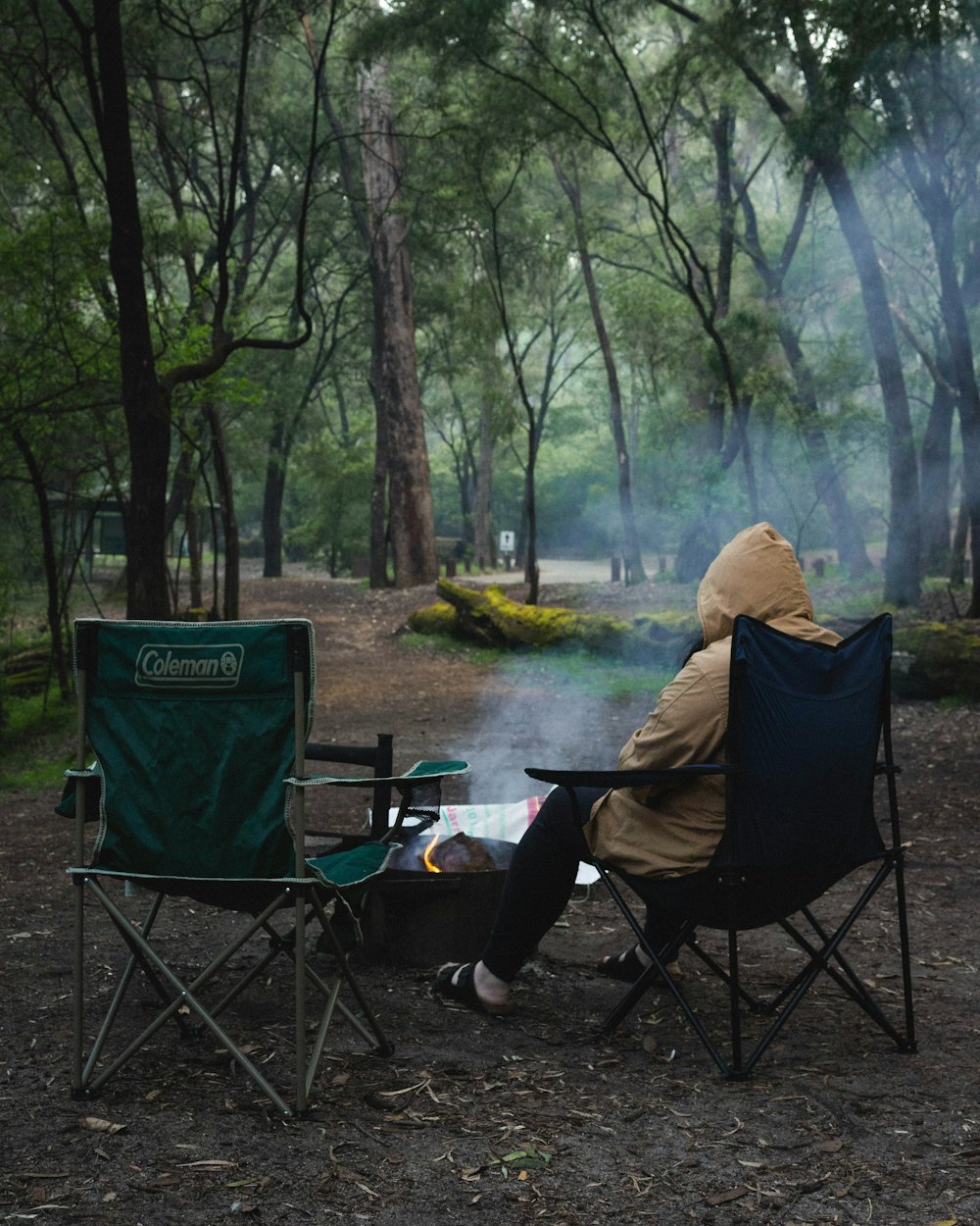 man in brown hoodie sitting on black chair