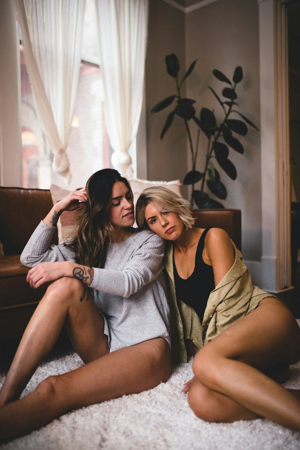 2 women sitting on couch