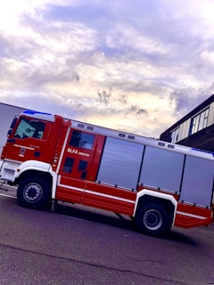 A fire truck parked in front of a commercial building.