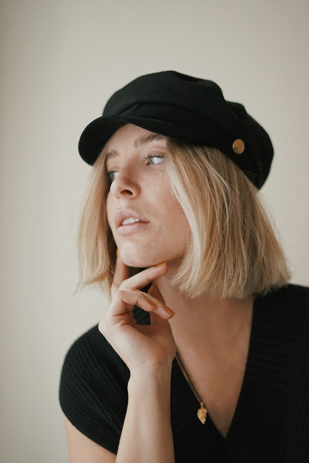 woman in black long sleeve shirt wearing black hat
