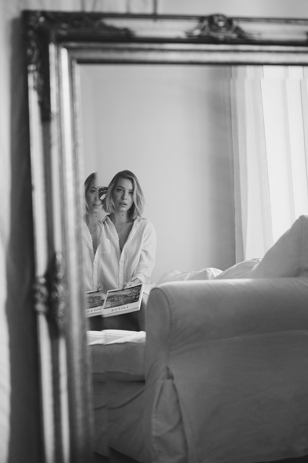 woman in white robe sitting on couch