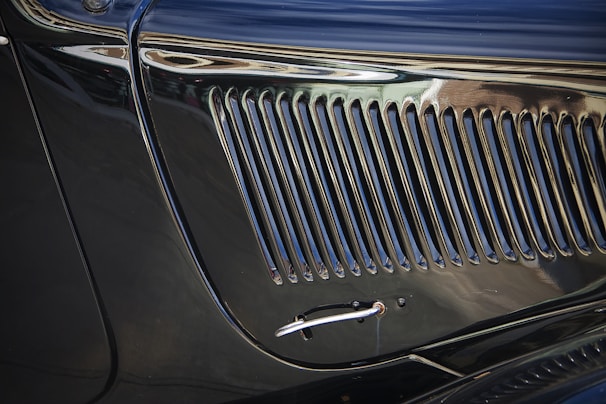 Close-up of a polished chrome grille on a classic luxury car.