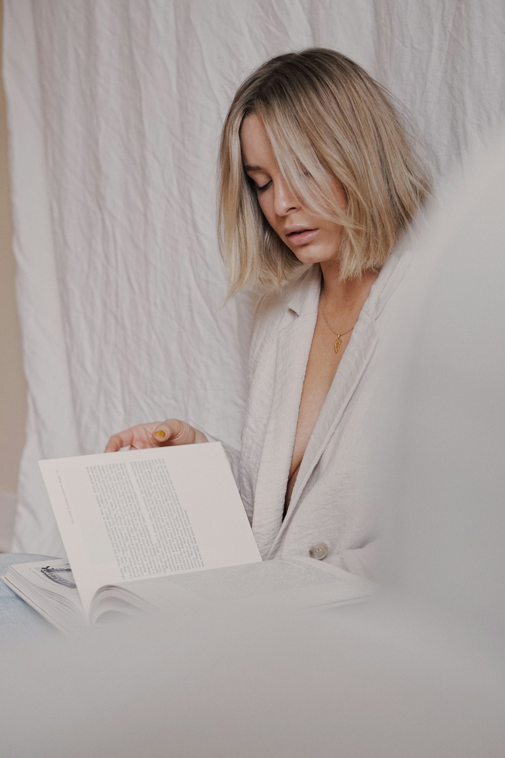 woman in white robe reading book